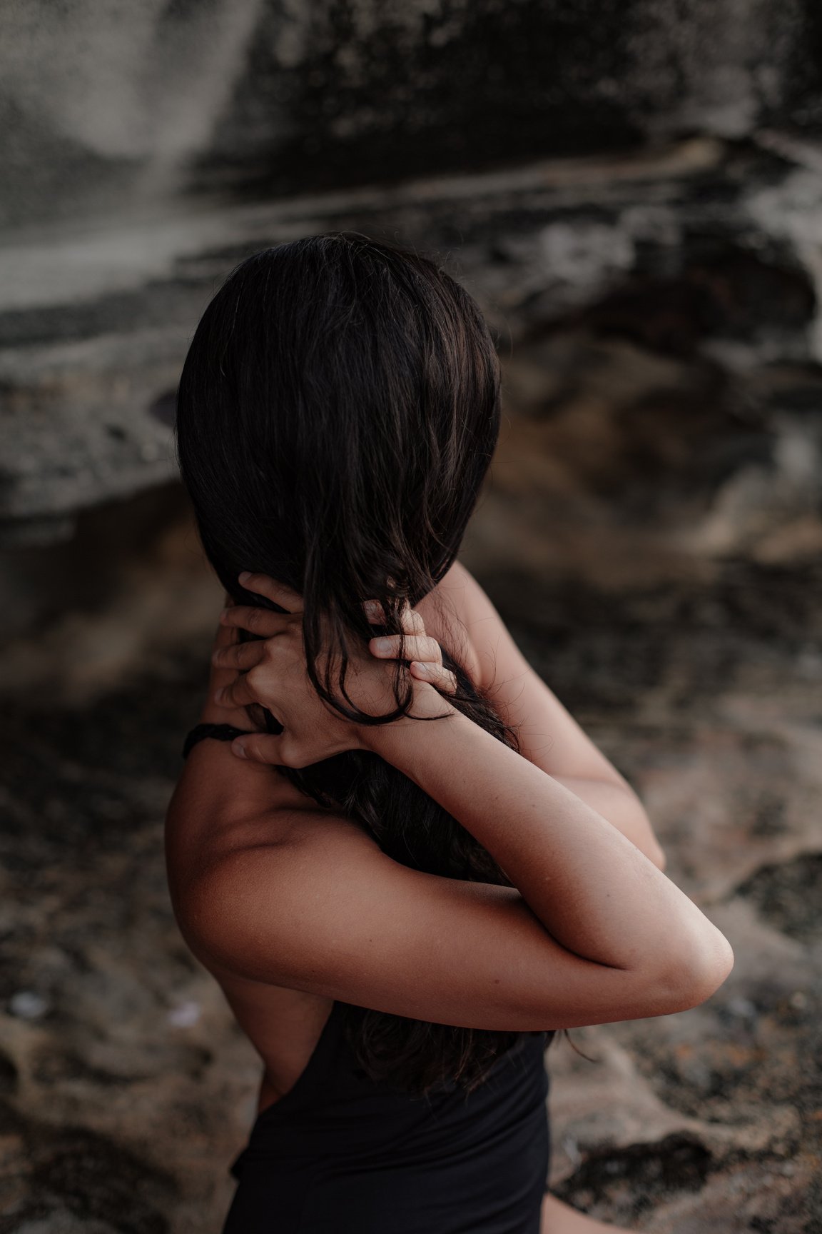 Woman in Black Top Holding Her Hair